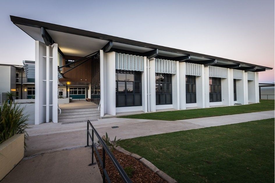 Modern Building With White Pillars and Windows, Angled Roof, and Pathway Leading to the Entrance — BOLD Architecture + Interior Design In Mackay, QLD