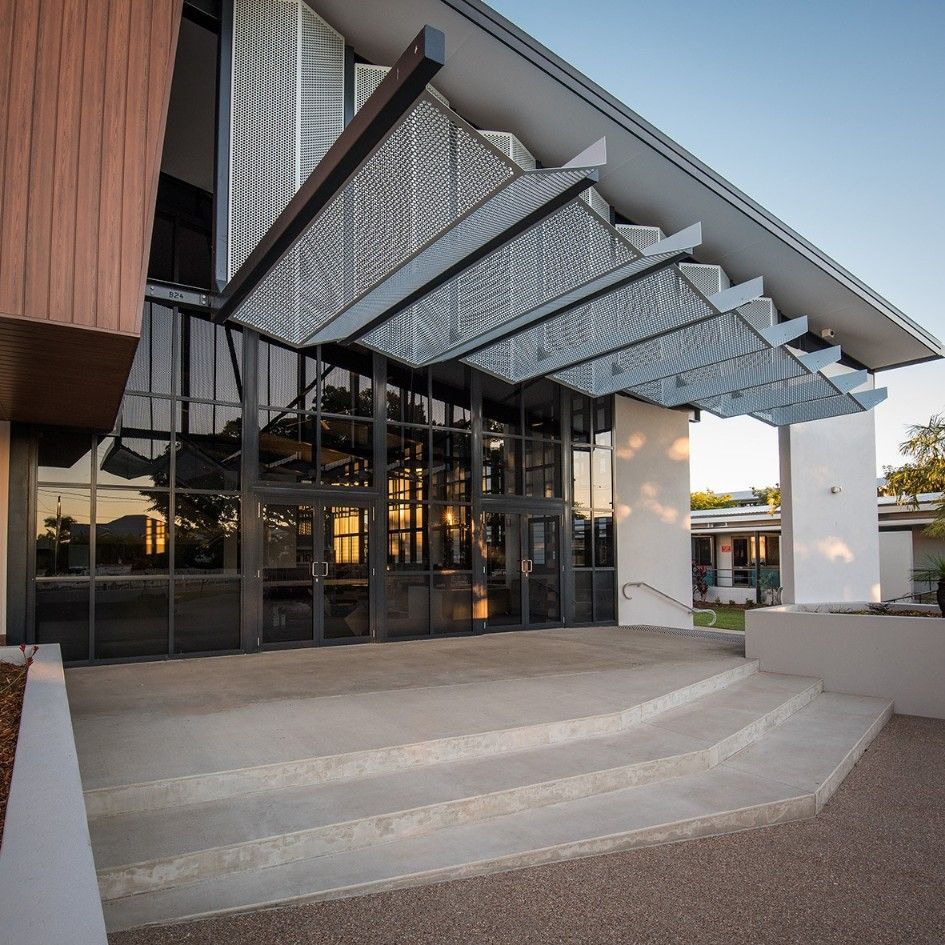 Modern Building Entrance With Glass Doors, Concrete Steps, and a Metal Canopy — BOLD Architecture + Interior Design In Mackay, QLD