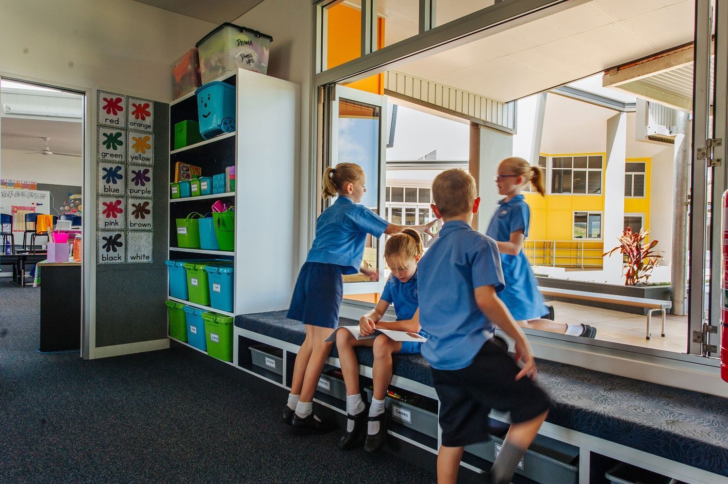 Children in School Uniforms Inside and Outside, Near a Window. One is Sitting, One Patting Another's Head — BOLD Architecture + Interior Design In Mackay, QLD
