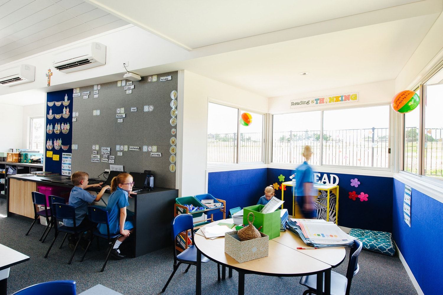 School Classroom With Students at Desks and Reading Area With Low Seating Near Windows — BOLD Architecture + Interior Design In Mackay, QLD