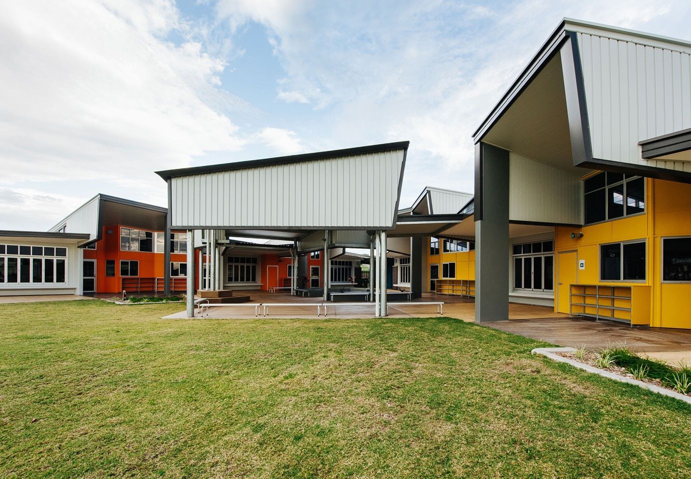 School Buildings With Orange and Yellow Walls, Under a Bright Sky — BOLD Architecture + Interior Design In Mackay, QLD