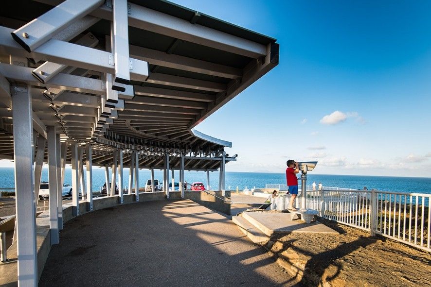 Person Using Binoculars on a Coastal Observation Deck. Blue Ocean, Sky. Metal Structure With Shade — BOLD Architecture + Interior Design In Mackay, QLD