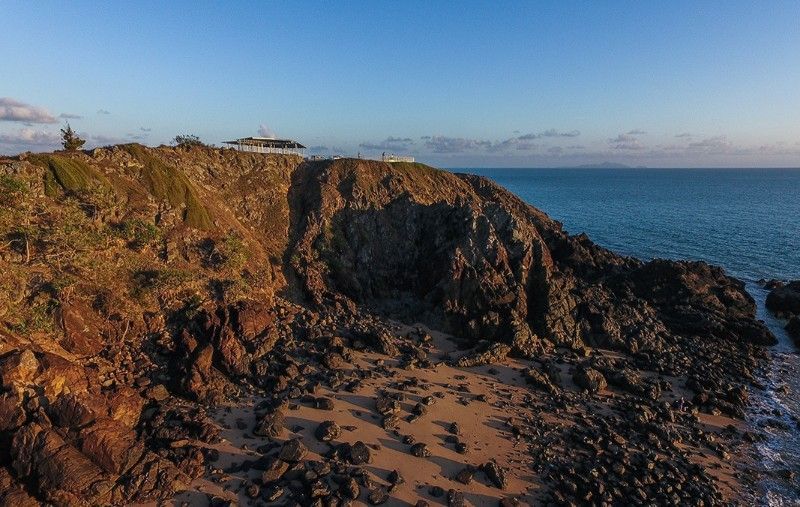 Rocky Cliff at Sunset, Ocean View. Building and Foliage on Top — BOLD Architecture + Interior Design In Mackay, QLD