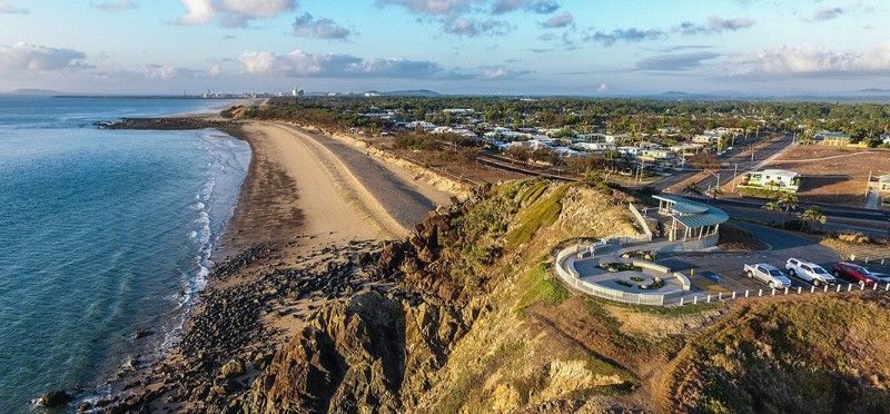Aerial View of a Coastal Town With Beach, Ocean, and Cliffs — BOLD Architecture + Interior Design In Mackay, QLD