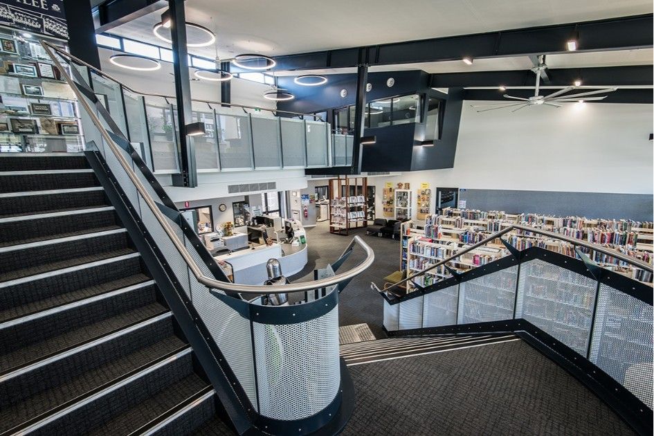 Staircase Leads Up to a Library's Reception Area. Black and White Design, Modern Interior With Books — BOLD Architecture + Interior Design In Mackay, QLD