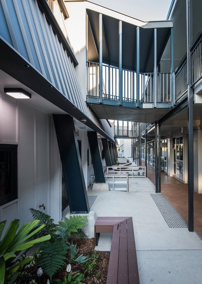 Exterior View of a Modern Building With a Walkway, Benches, and Greenery — BOLD Architecture + Interior Design In Mackay, QLD