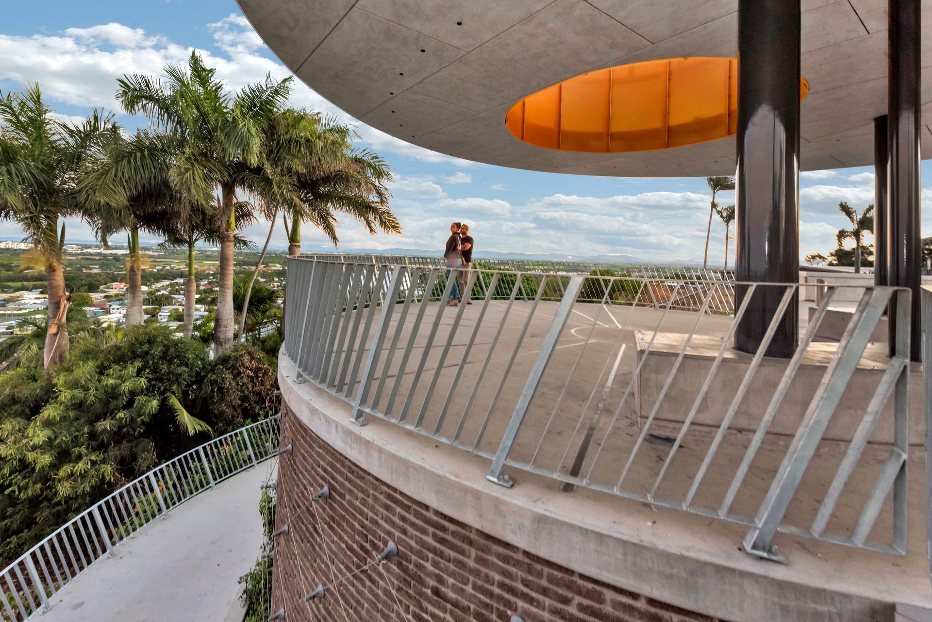 A Circular Viewing Platform With Metal Railings and a Woman Looking Out — BOLD Architecture + Interior Design In Mackay, QLD
