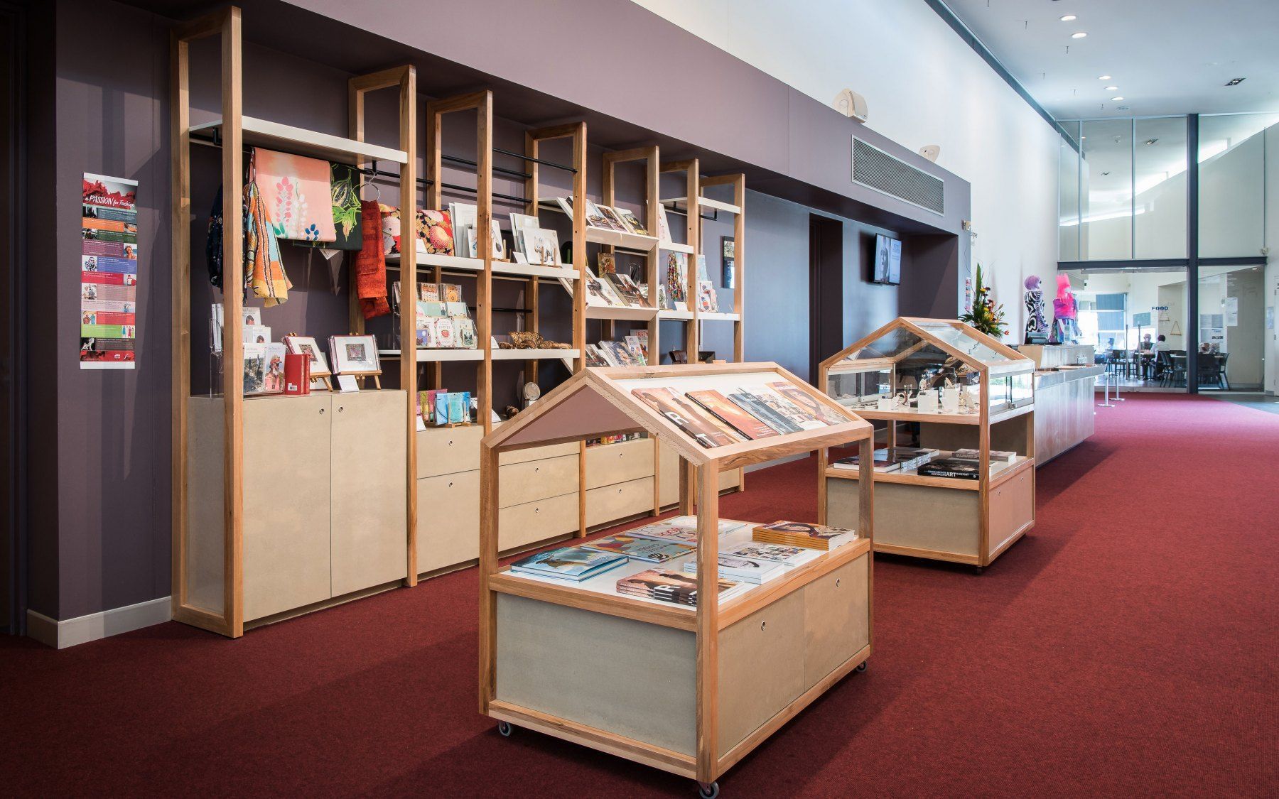 A Store With Wooden Shelves Displaying Merchandise on a Red Carpet — BOLD Architecture + Interior Design In Mackay, QLD