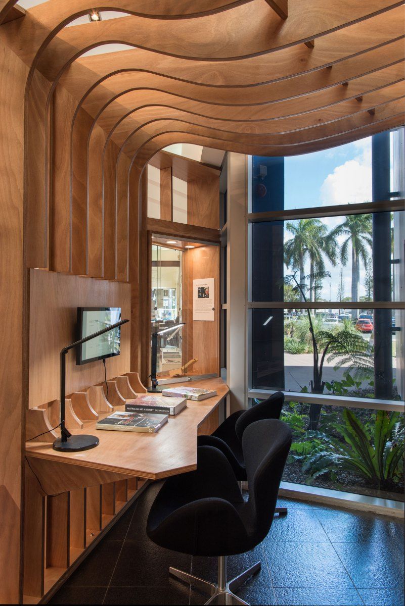 Wooden Desk Nook With Black Chairs, a Window Overlooking Greenery and Palm Trees — BOLD Architecture + Interior Design In Mackay, QLD