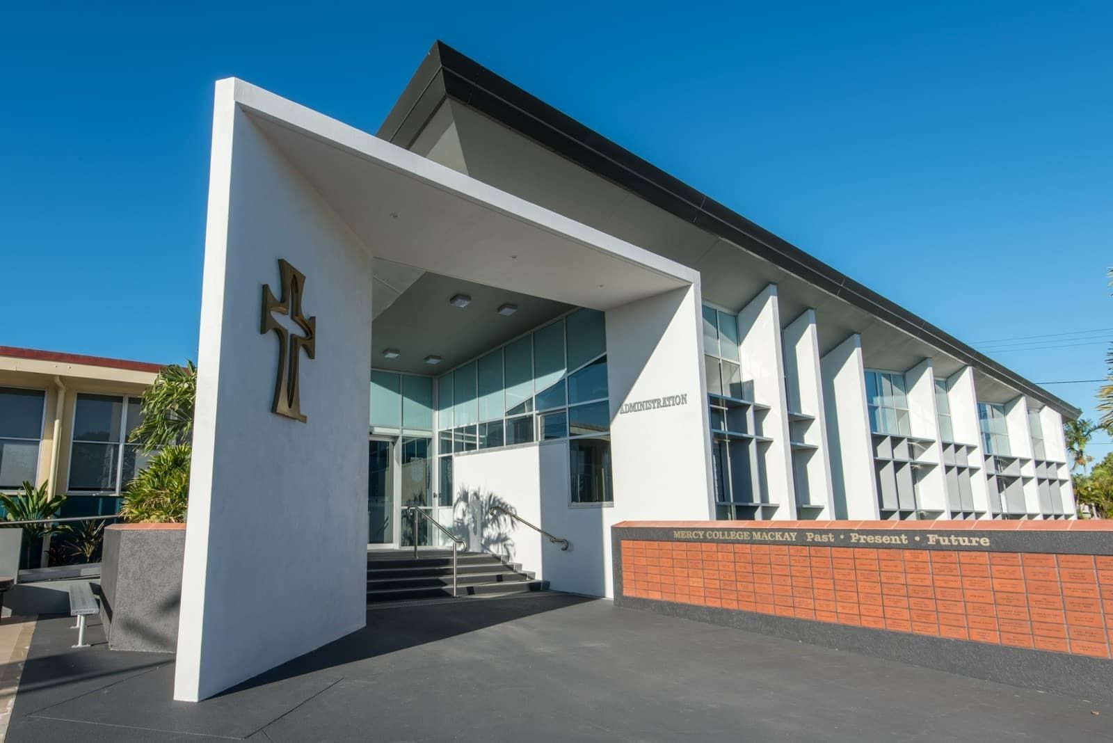 Modern White Church with A Cross, Glass Front, Brick Wall, and Black Roof — BOLD Architecture + Interior Design In Mackay, QLD