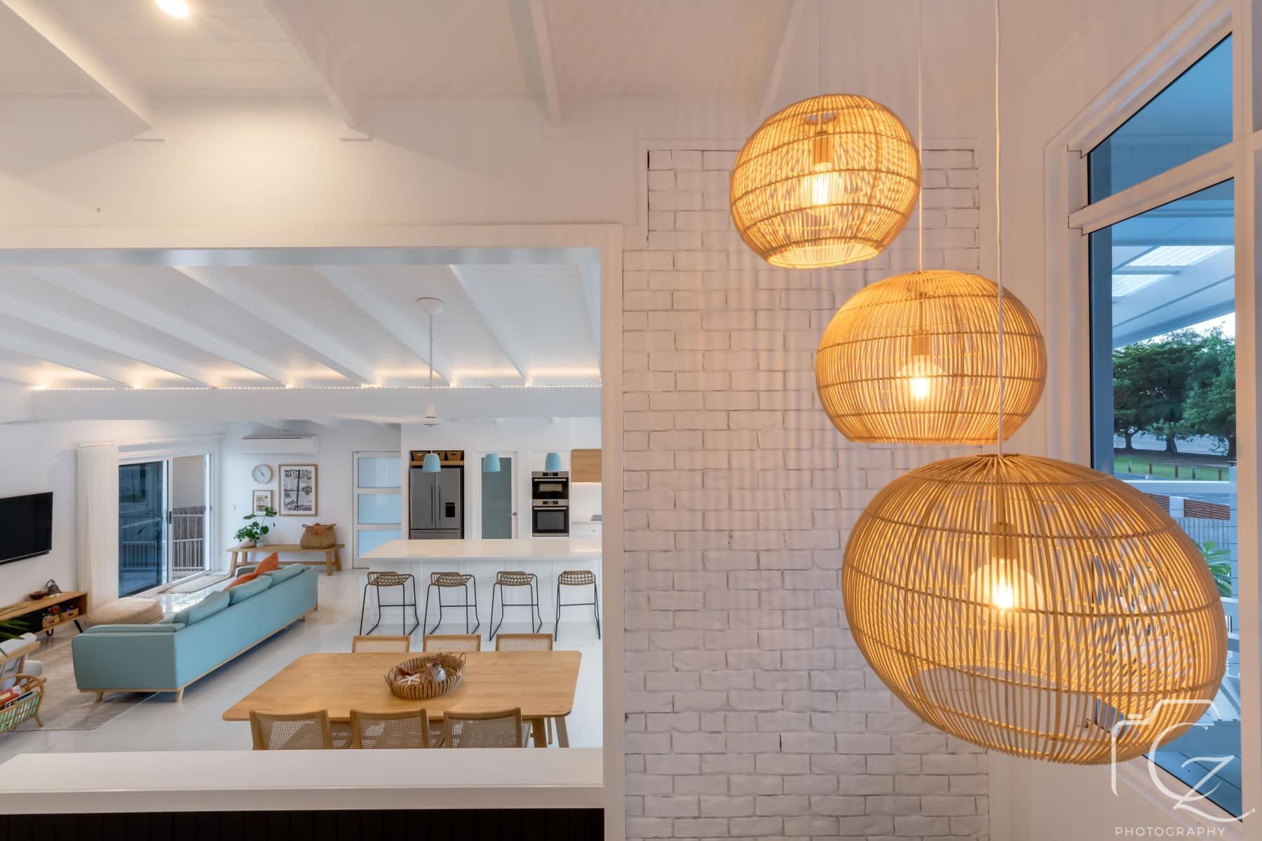 Three Woven Pendant Lights Hang in Front of A White Brick Wall — BOLD Architecture + Interior Design In Mackay, QLD