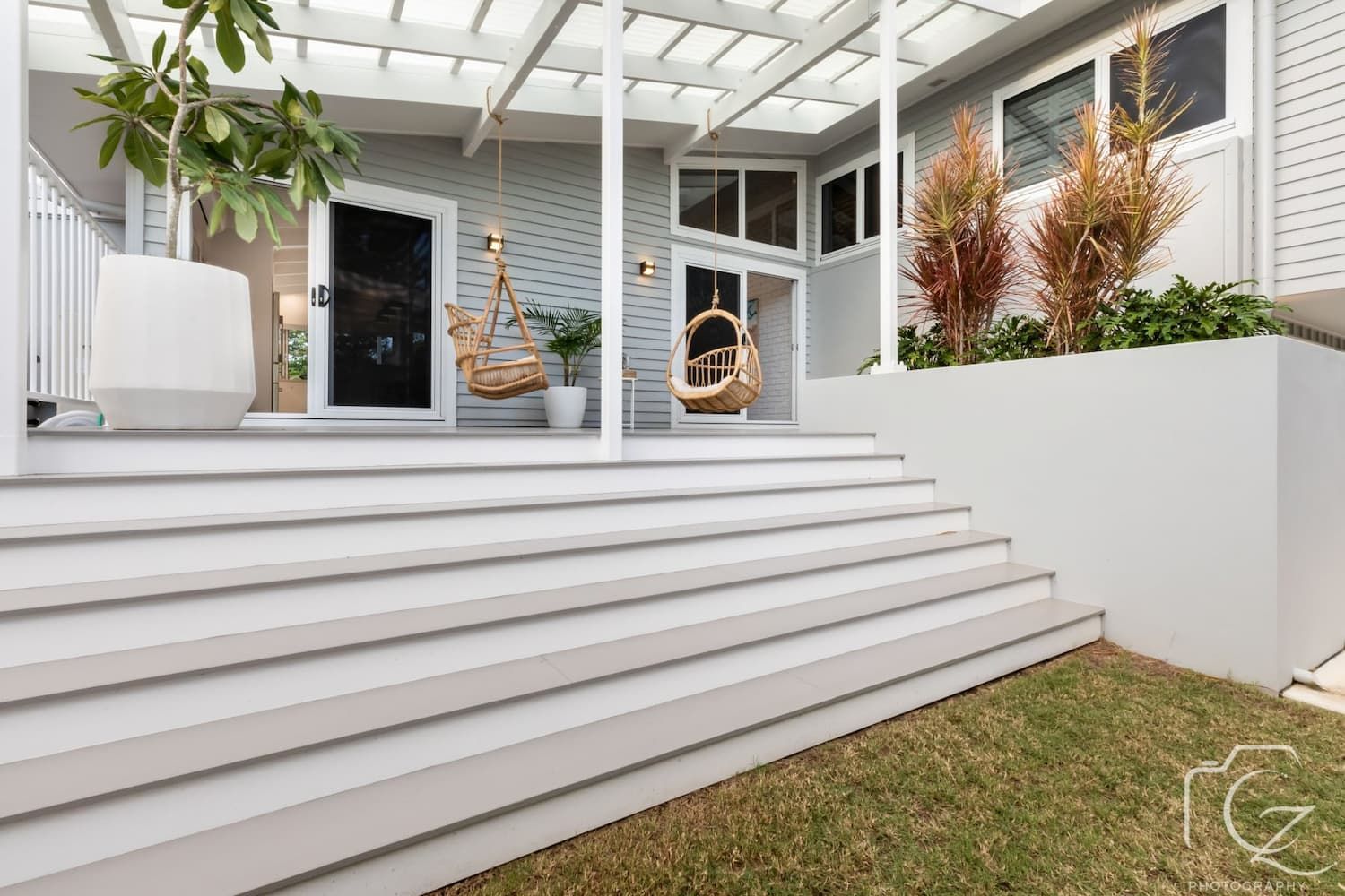 Gray and White Patio with Steps, Porch Swings, and A Small Garden — BOLD Architecture + Interior Design In Mackay, QLD