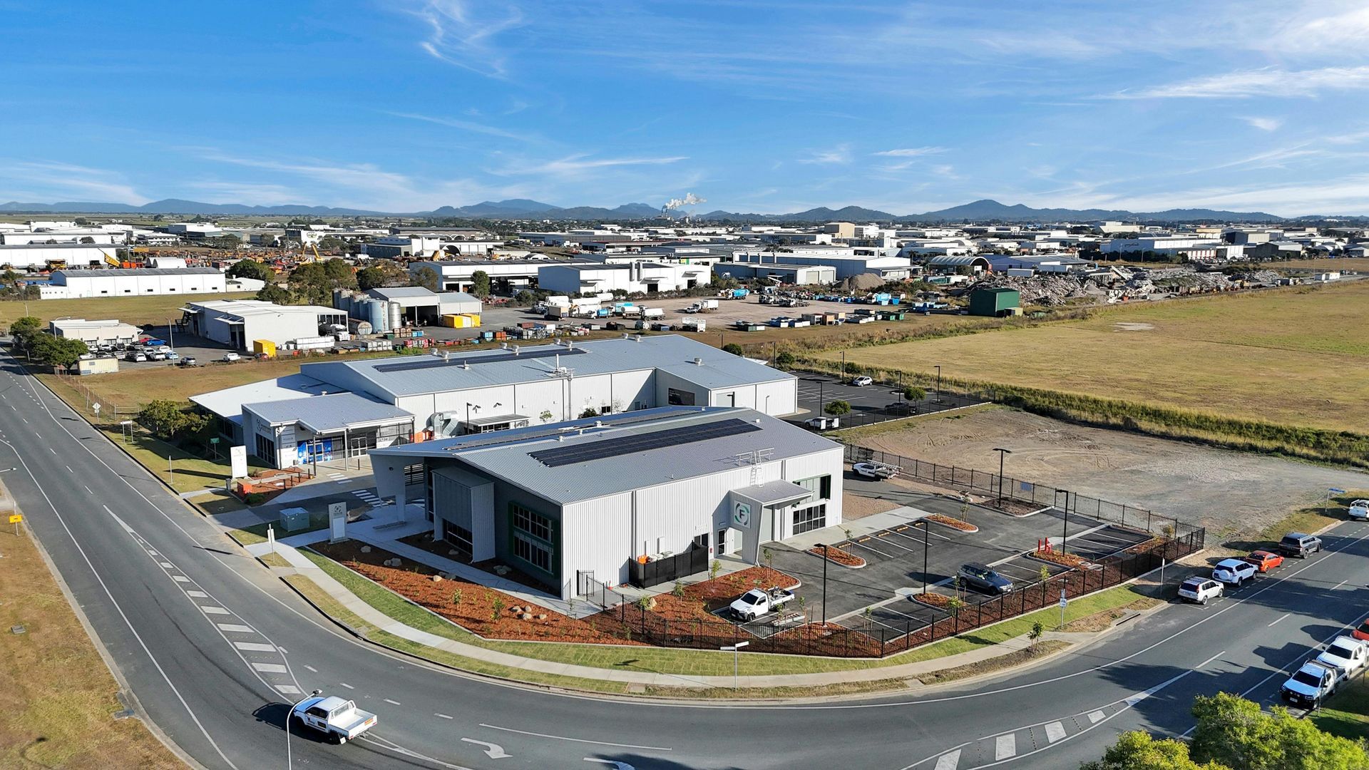 An Aerial View of a Modern Industrial Building With Solar Panels on Its Roof — BOLD Architecture + Interior Design In Mackay, QLD