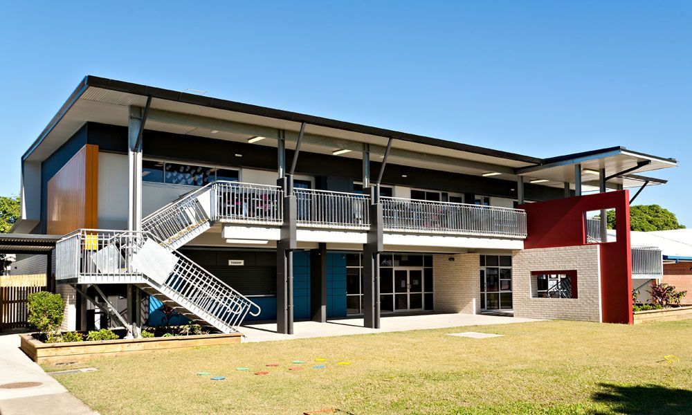 Modern Two-story School Building With Orange, Blue, and Black Accents, a Balcony — BOLD Architecture + Interior Design In Mackay, QLD