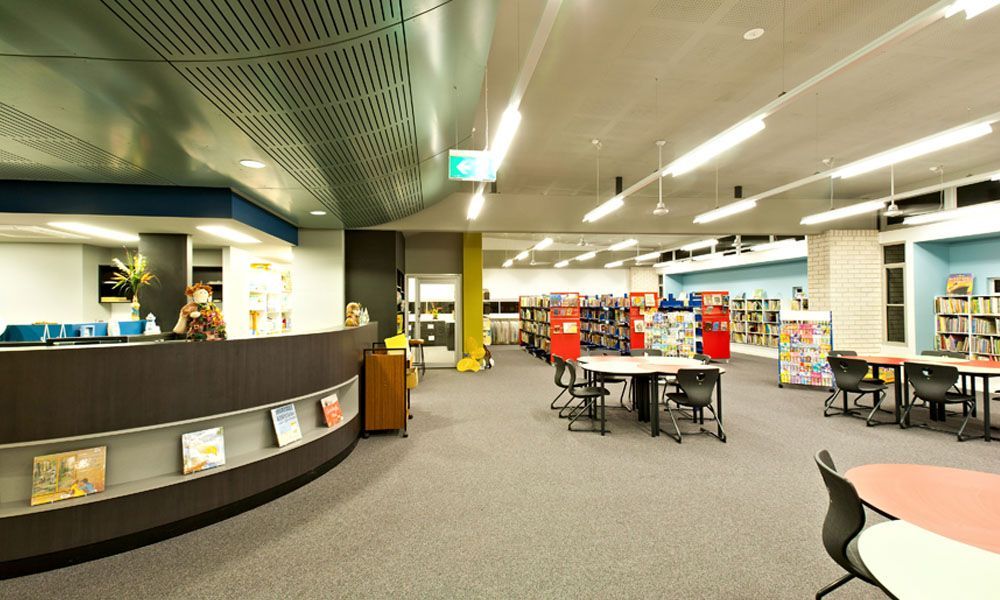 Library Interior With Reception Desk, Bookshelves, Tables, and Chairs — BOLD Architecture + Interior Design In Mackay, QLD