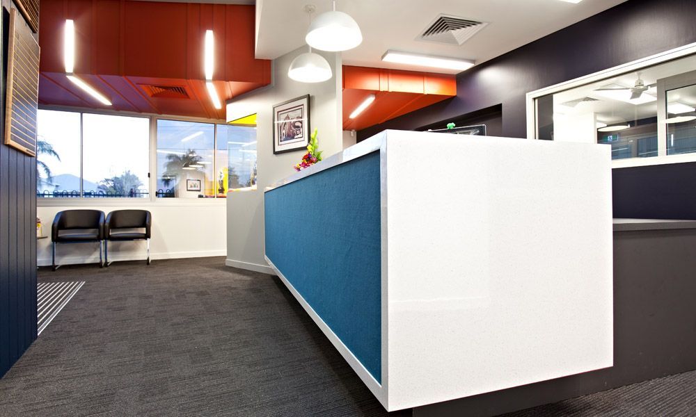 Modern Office Reception Area With White and Blue Reception Desk — BOLD Architecture + Interior Design In Mackay, QLD