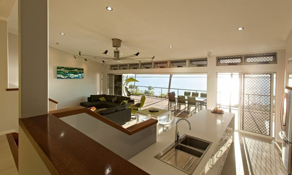 Open-Plan Kitchen with Island Counter, Overlooking a Dining Area and Ocean View — BOLD Architecture + Interior Design In Mackay, QLD