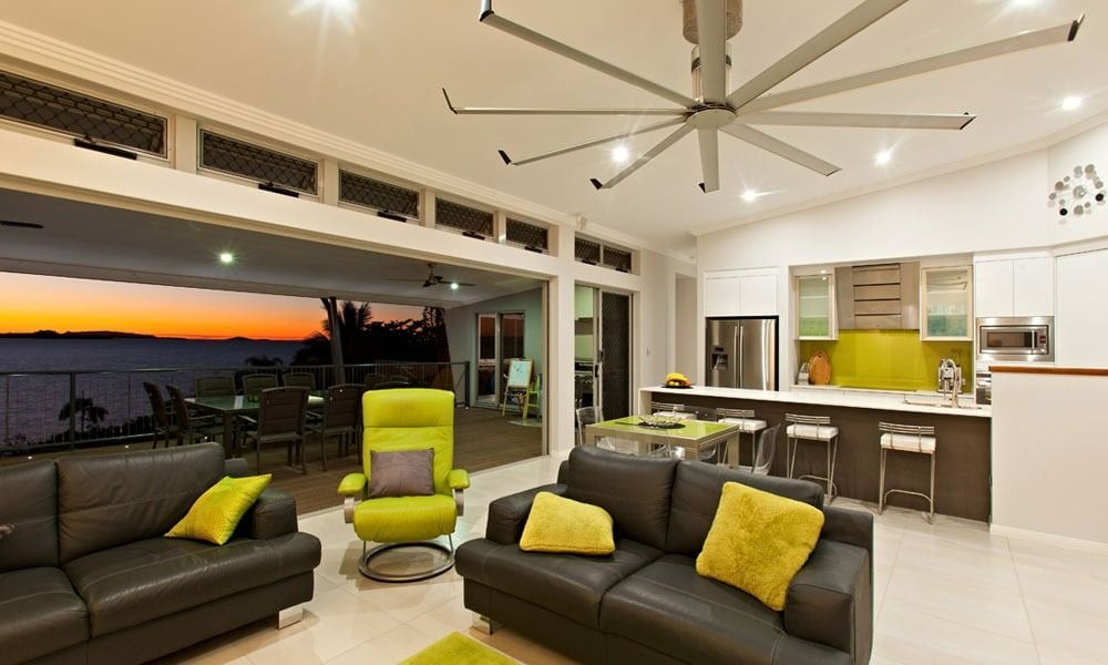 Living Room with Ocean View, Gray Leather Sofas, Green Chair, and Kitchen with Lime-Green Backsplash — BOLD Architecture + Interior Design In Mackay, QLD