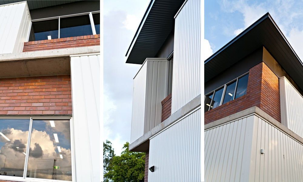 Exterior Shots of a Modern Building With White Siding, Brick Accents, and a Dark Roof Against a Blue Sky — BOLD Architecture + Interior Design In Mackay, QLD