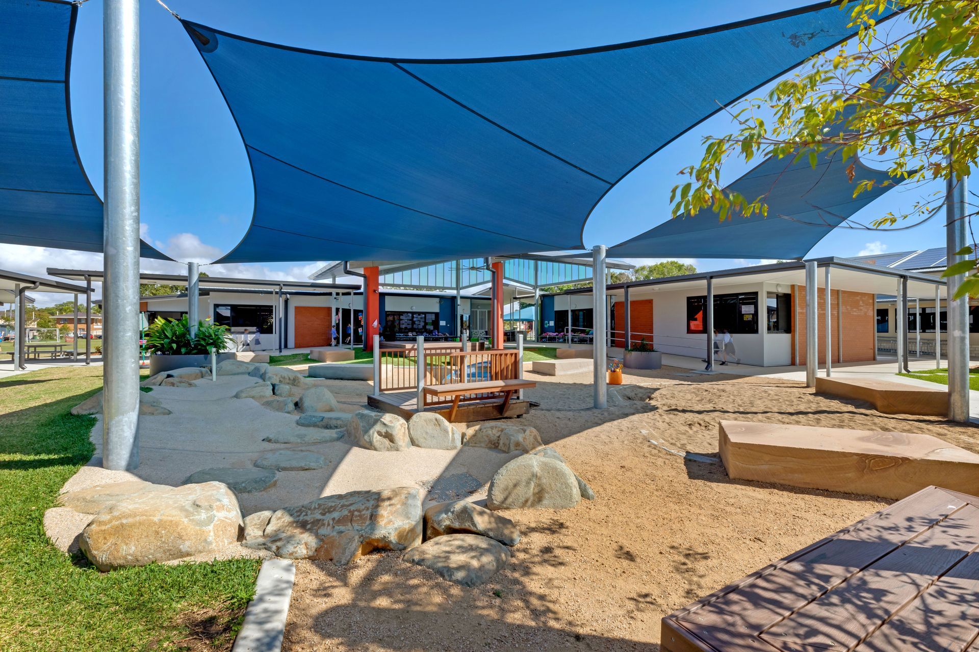Outdoor School Playground With Blue Shade Sails and Sandpit — BOLD Architecture + Interior Design In Mackay, QLD