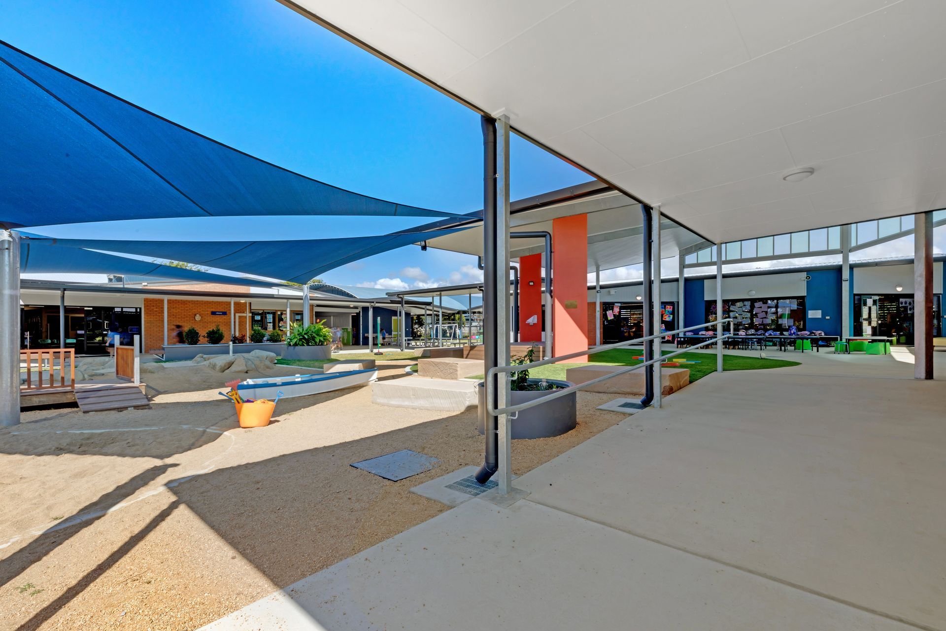 Courtyard With Shade Sails, Gravel, and Building — BOLD Architecture + Interior Design In Mackay, QLD