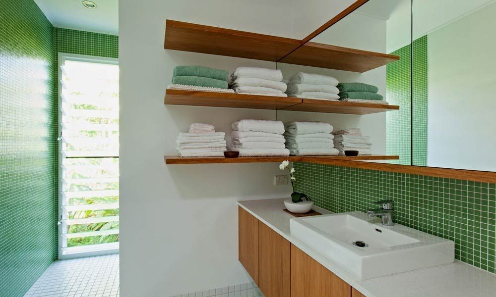 A Bathroom With A Sink And Shelves Filled With Towels — BOLD Architecture + Interior Design In Mackay, QLD