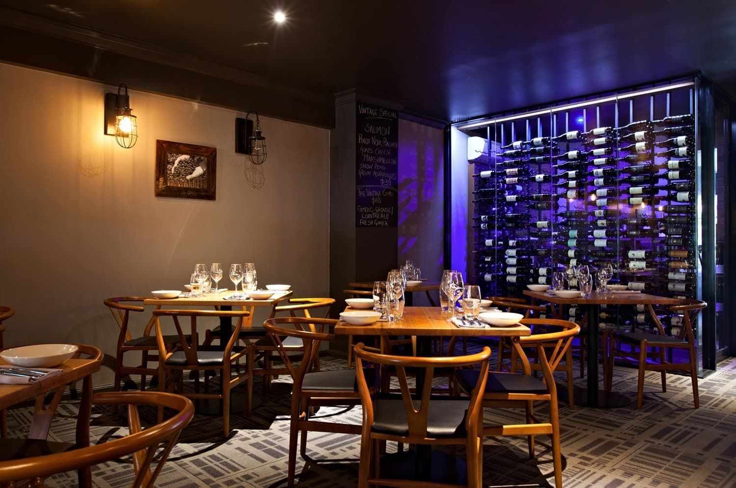 Restaurant Interior: Tables Set for Dining, Wooden Chairs, Wine Rack, Soft Lighting — BOLD Architecture + Interior Design In Mackay, QLD