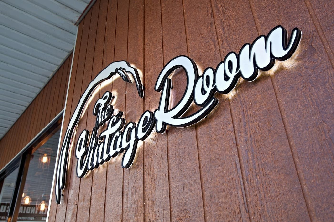 Sign On A Brown, Wood-Paneled Building. White Text with A Black Outline — BOLD Architecture + Interior Design In Mackay, QLD