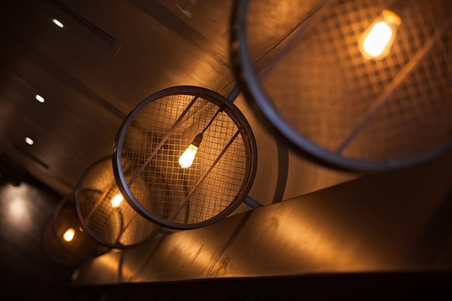 Circular Metal Pendant Lights with Exposed Bulbs, Warm Glow — BOLD Architecture + Interior Design In Mackay, QLD