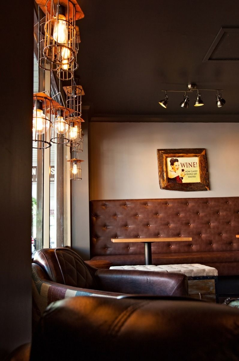 Cozy Cafe Interior with Leather Seating, Hanging Lights, and A Framed Picture — BOLD Architecture + Interior Design In Mackay, QLD