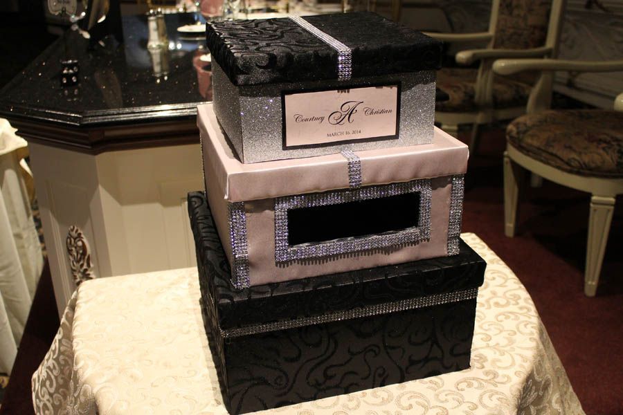 Three stacked decorative boxes with glitter accents.