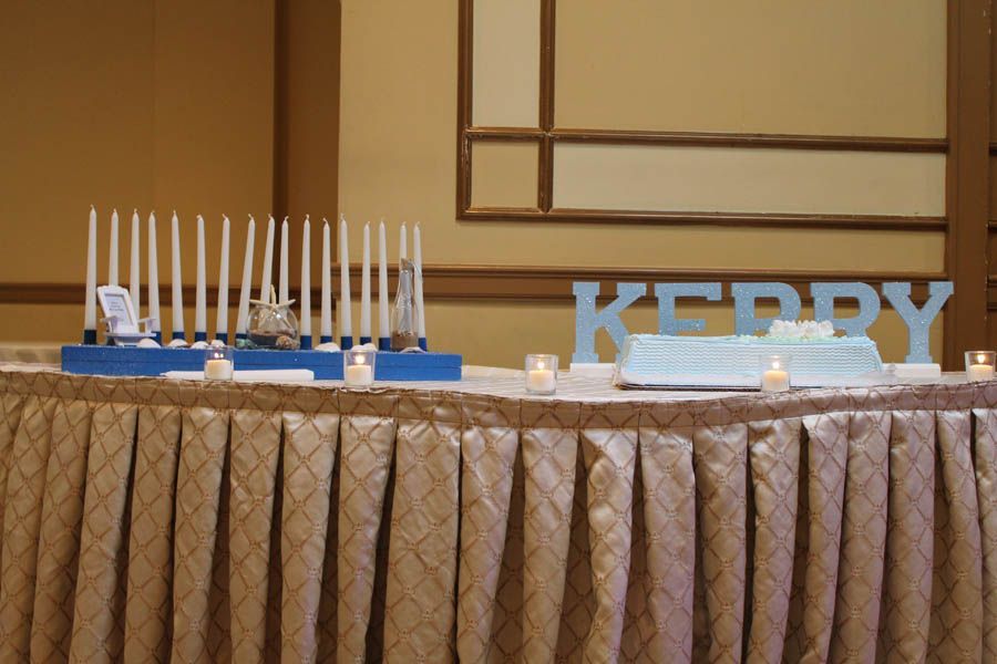 A table with candles, cake, and name 