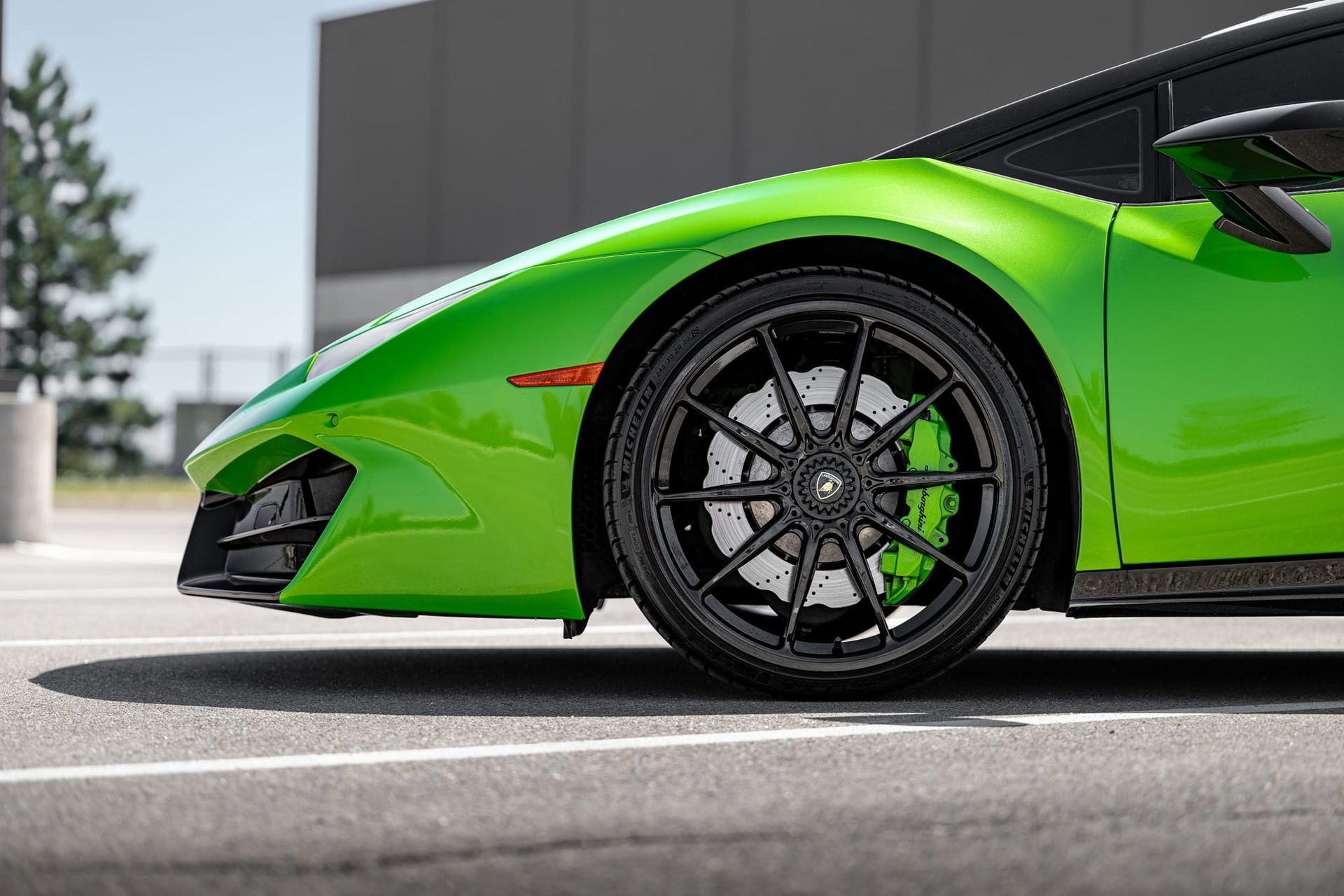 A close up of a black car wheel with a tire on it.