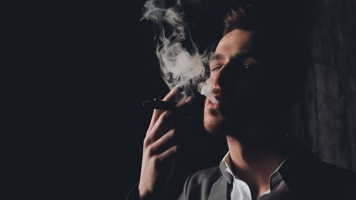 A man smoking cigar A man smoking cigar