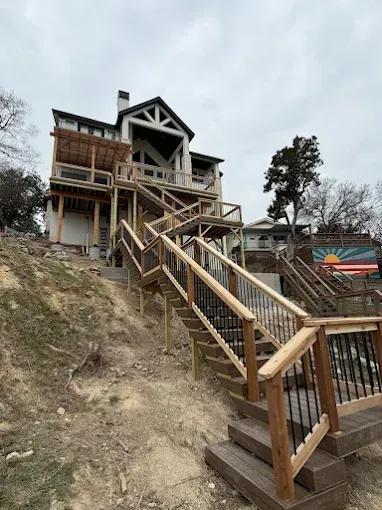 Wooden stairway leading up a steep hillside to a house under construction