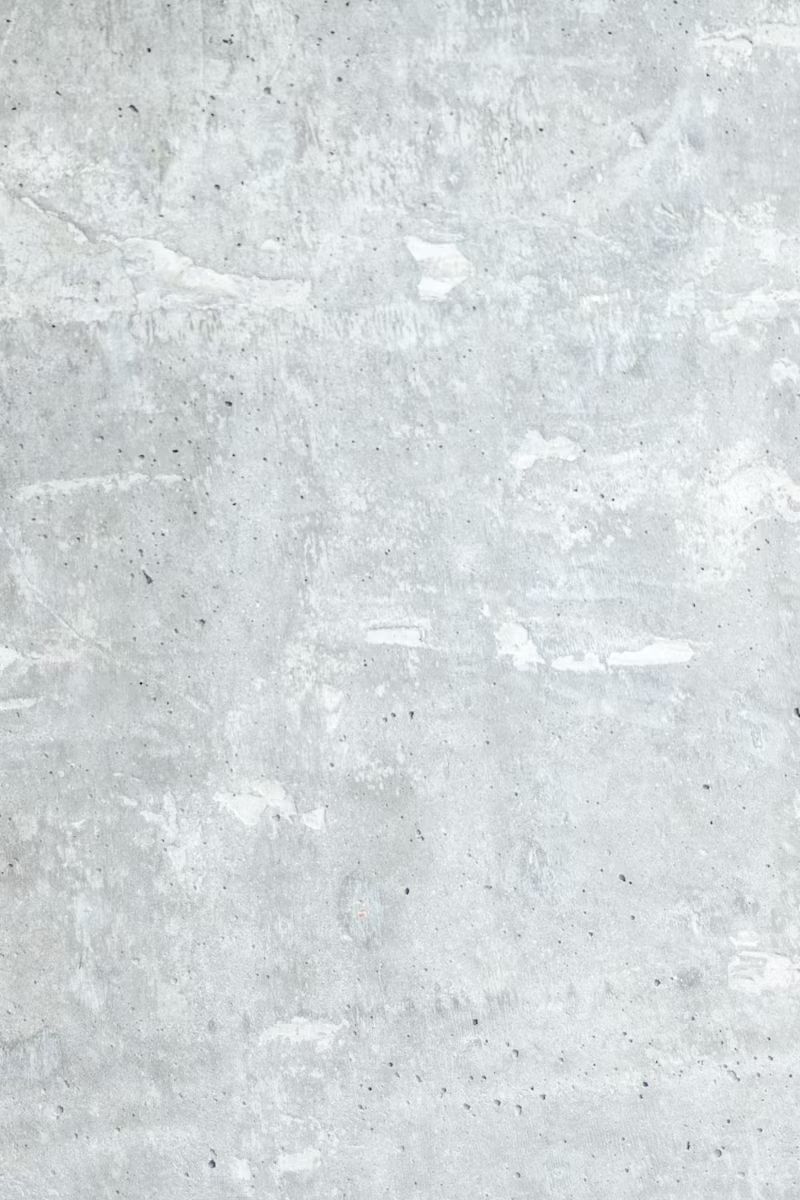 Light gray concrete wall with subtle white streaks and mottled texture