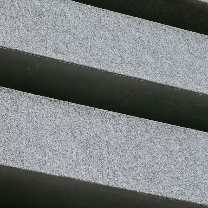 Close-up of two light gray textured strips with a dark diagonal gap between them