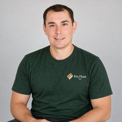Dmytro Lobzun, owner of Pro Floors Inc., wearing a green company T-shirt.