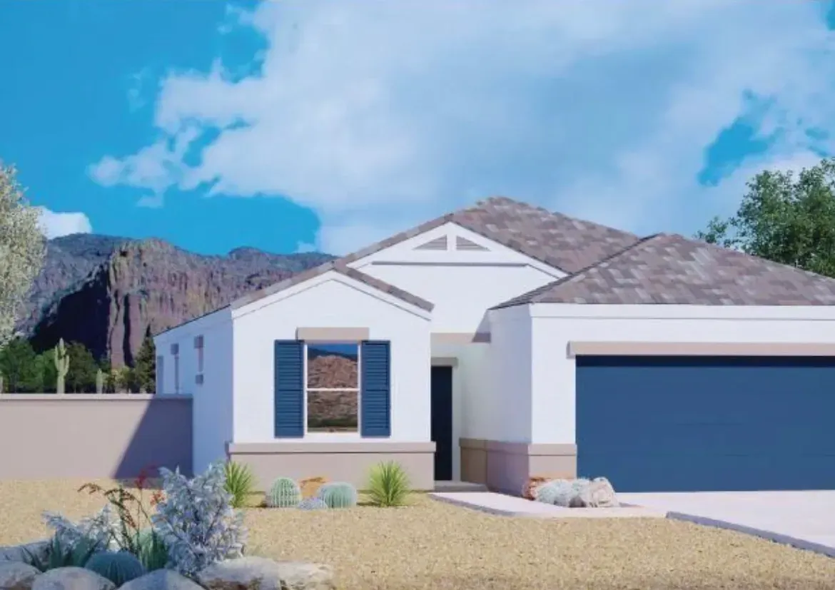 Modern white house with blue garage door, desert landscaping, and mountains under a blue sky.