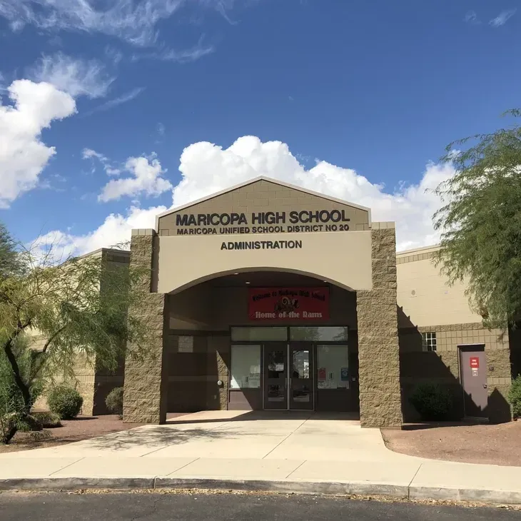 Maricopa High School administration entrance under a blue sky with clouds