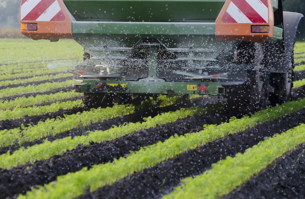 Agriculture And A Farmer Spraying Fertilizer On His Carrots — Agricultural Fertiliser in Gympie, QLD