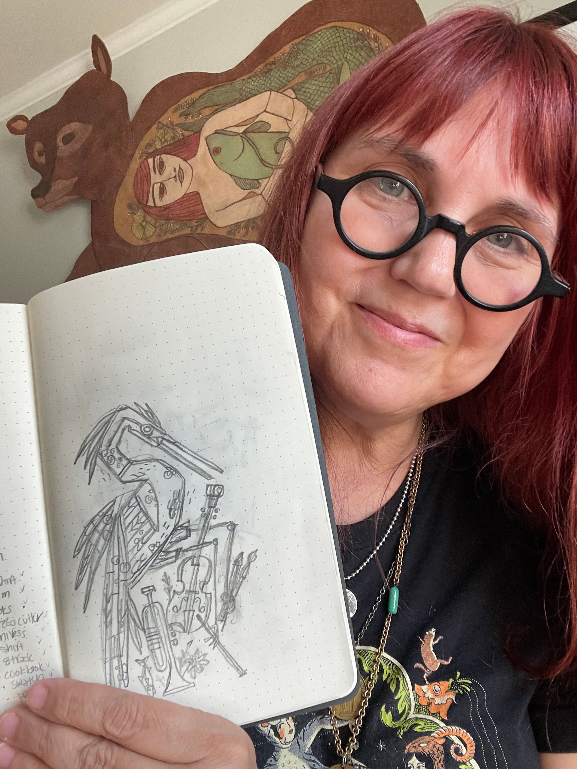 Picture of Illustrator Denise Gallagher with her sketch of the stylized egret for the new state license plate. 