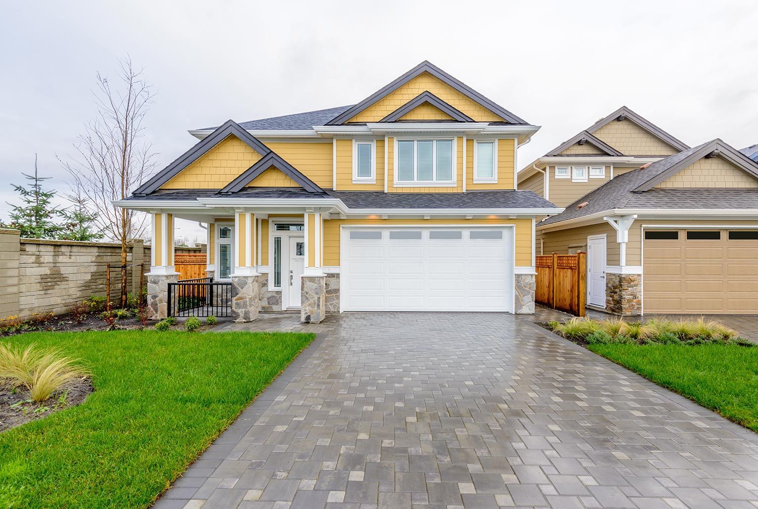 House with white garage and paved driveway