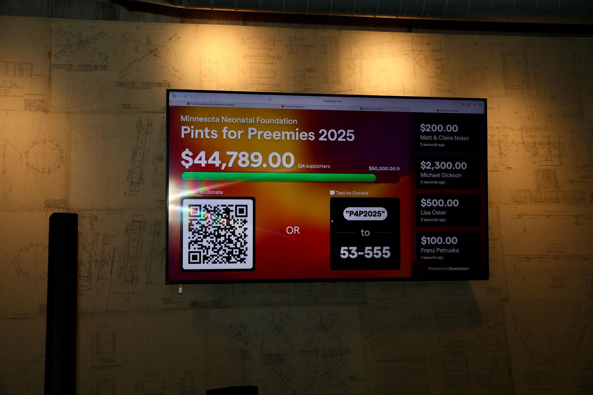 A digital display shows a fundraising progress bar for 