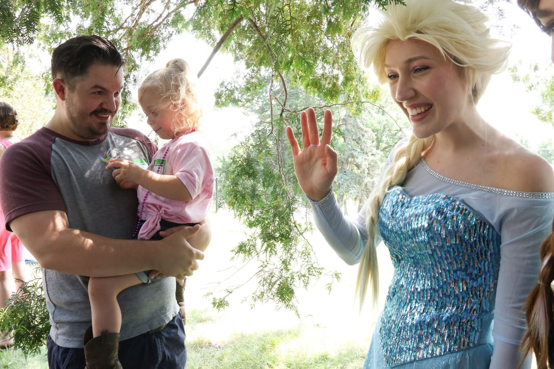 Man holding a child meets Elsa from 