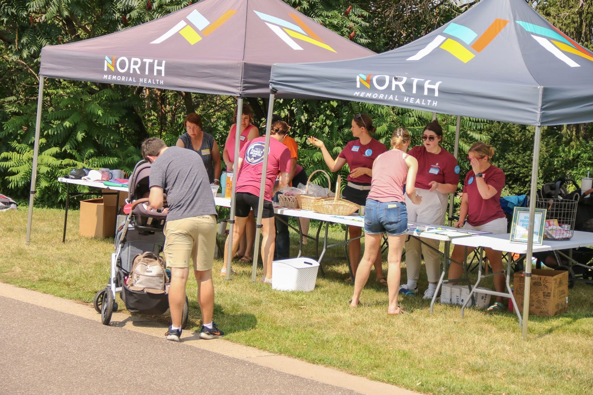 People at a table under a tent labeled 