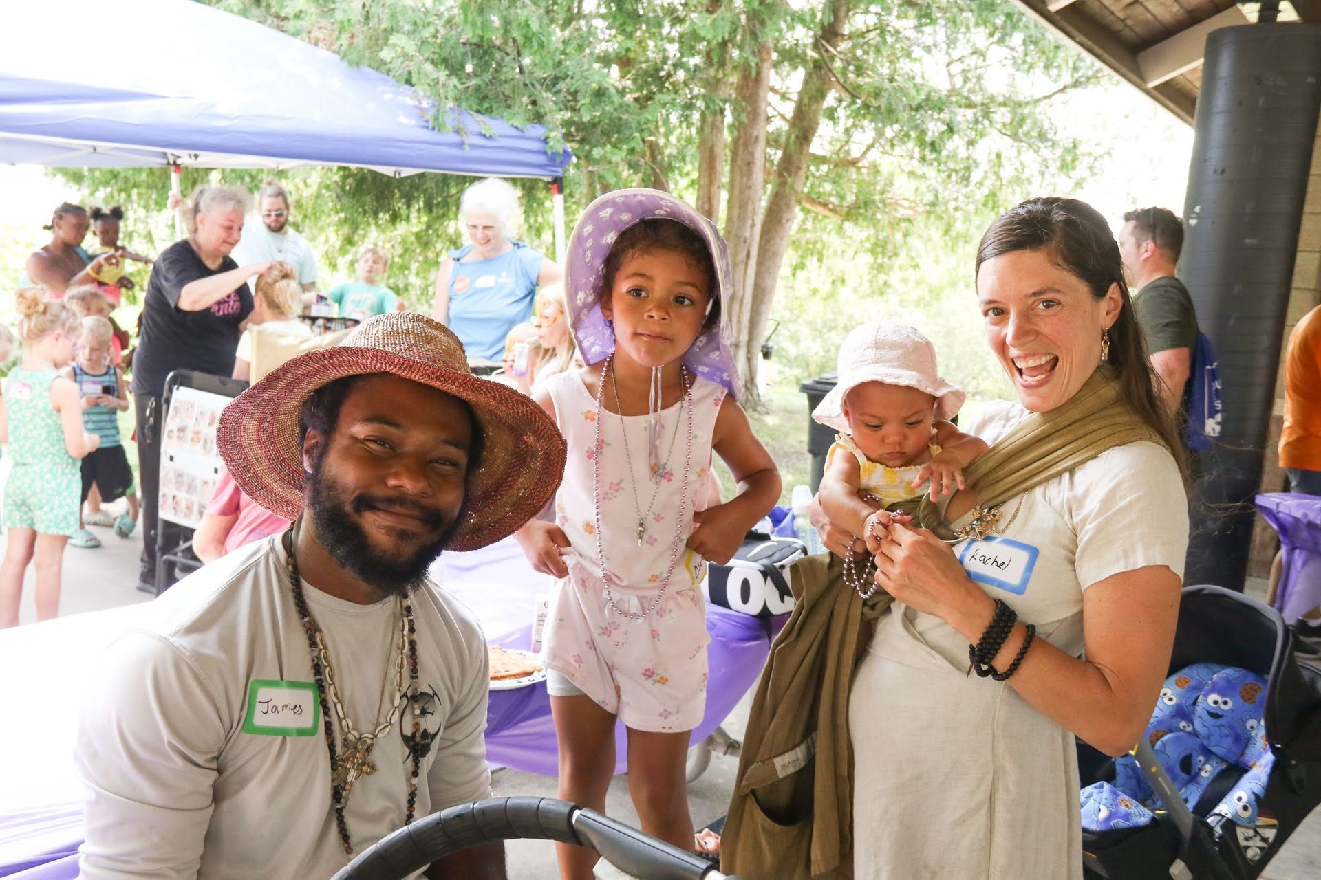 Group of people at an outdoor event, smiling and posing.