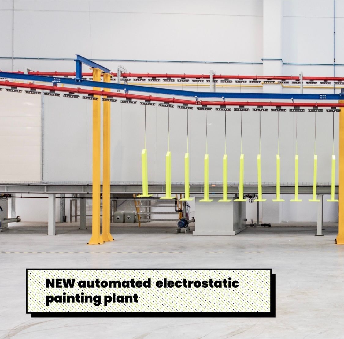 Impianto di verniciatura elettrostatica automatizzato con pali gialli sospesi in ambiente industriale.