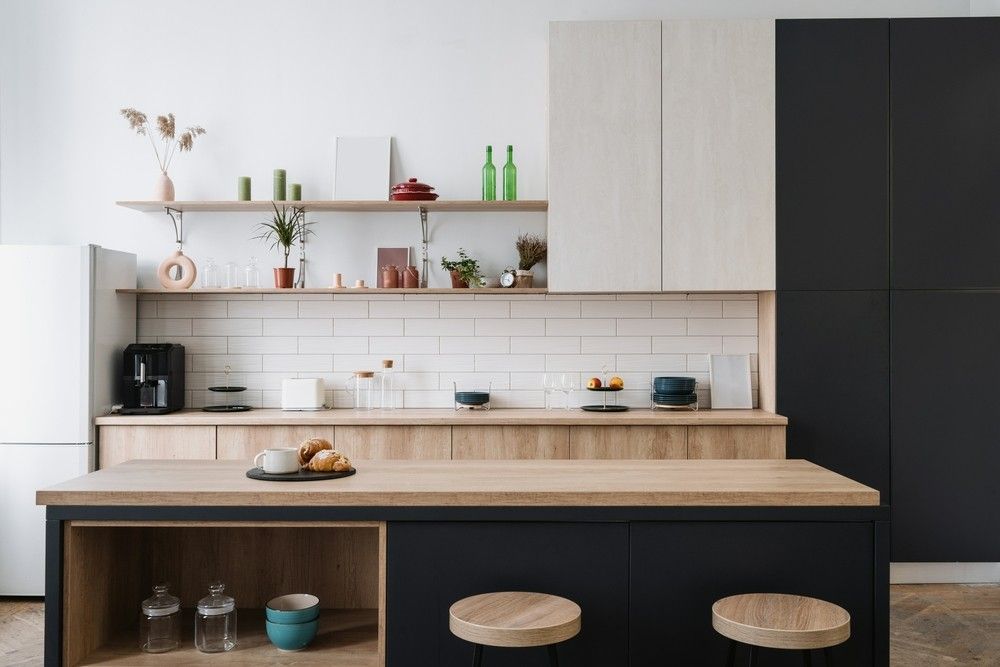 A Kitchen With Black Cabinets, Wooden Counter Tops and Stools — Elite Stone in Gold Coast, QLD