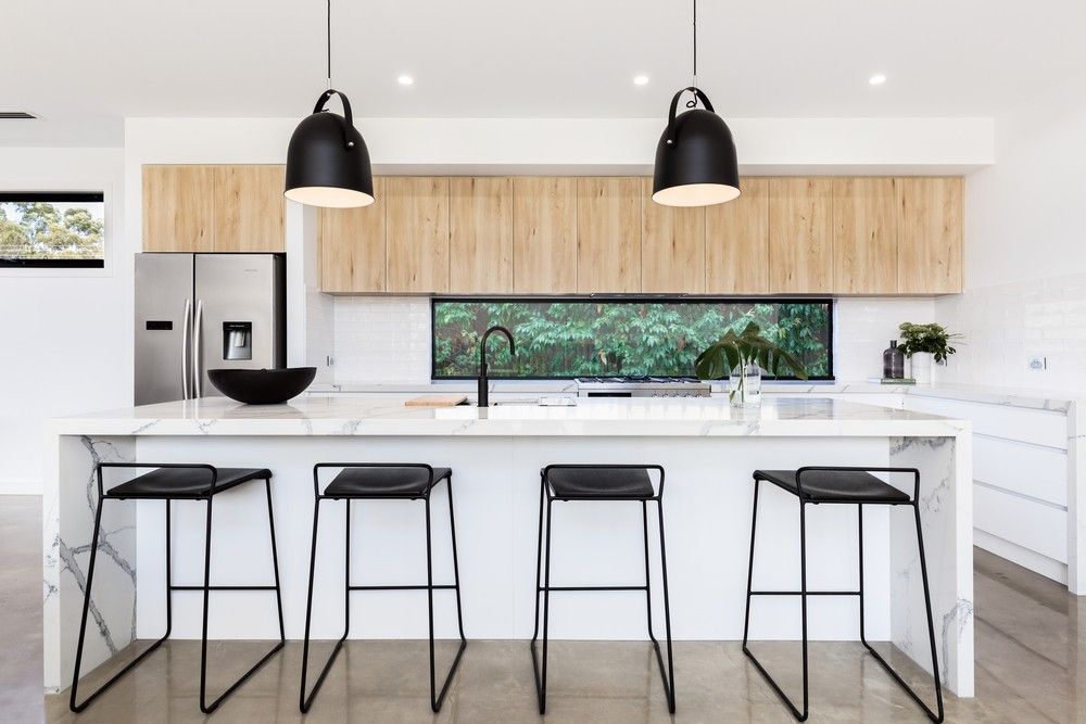 A Kitchen With a Large Island, Stools, and a Refrigerator — Elite Stone in Tweed Heads South, NSW